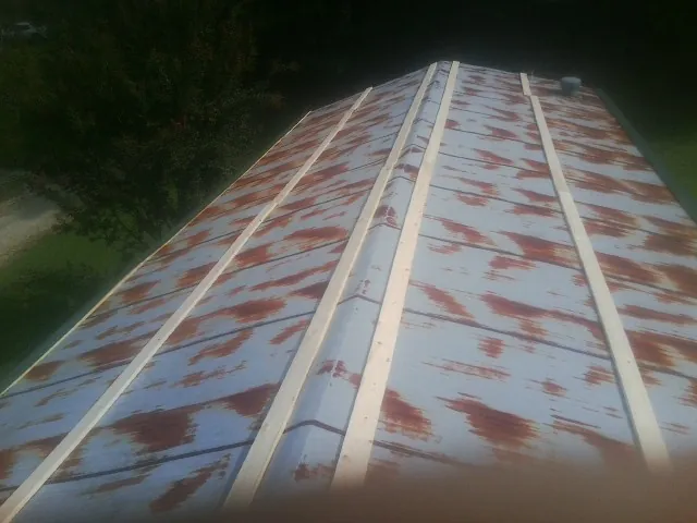 Rusted metal roof panels with new wood purlins before replacement — Storm Damage Roof Repair in Bear Mountain by Roofing Brothers
