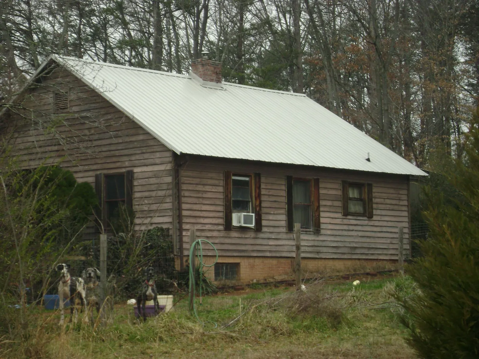 White metal roof on an old wood sided farmhouse, from a Metal Roof Installation job in Bear Mountain